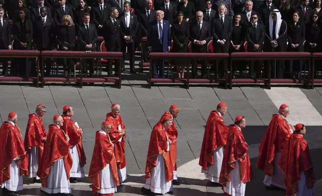 President Donald Trump, center right, with first lady Melania Trump, French President Emmanuel Macron, front row left center, and Finland's President Alexander Stubb, center left, and other dignitaries, attend the funeral of Pope Francis in St. Peter's Square at the Vatican, Saturday, April 26, 2025. (AP Photo/Evan Vucci)