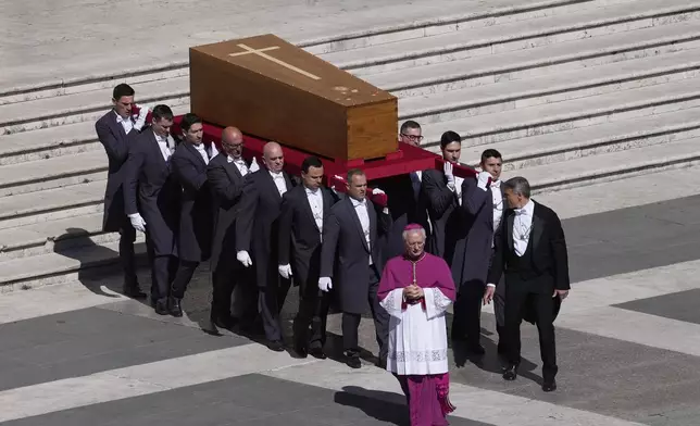 The coffin of Pope Francis is carried into St Peter's Square for his funeral, at the Vatican, Saturday, April 26, 2025. (AP Photo/Gregorio Borgia)