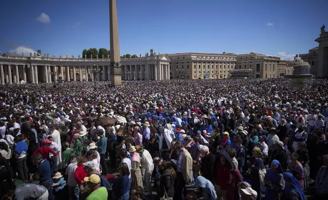 Faithful listen to mass during the funeral of Pope Francis in St. Peter's Square at the Vatican, Saturday, April 26, 2025. (AP Photo/Emilio Morenatti)