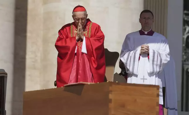 Dean of the College of Cardinals Giovanni Battista Re prays in front of the coffin during the funeral of Pope Francis in St. Peter's Square at the Vatican, Saturday, April 26, 2025. (AP Photo/Alessandra Tarantino)
