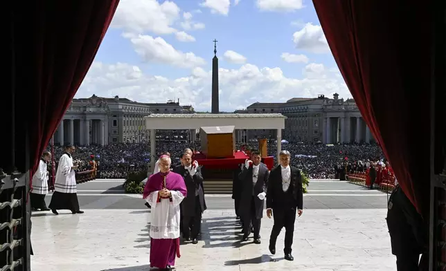 Vatican Master of Ceremonies Diego Giovanni Ravelli precedes the coffin containing the body of late Pope Francis being brought inside St. Peter's Basilica at the end of his solemn funeral in St. Peter's Square at the Vatican Saturday, April 26, 2025. (Vatican Media via AP)
