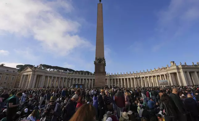People gather for the funeral of Pope Francis in St. Peter's Square at the Vatican, Saturday, April 26, 2025. (AP Photo/Andreea Alexandru)