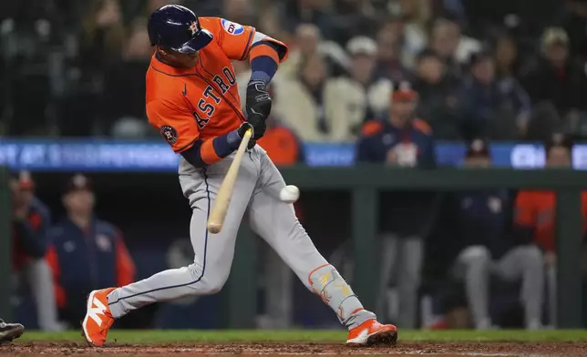 Houston Astros' Jeremy Peña hits a single against the Seattle Mariners during the fourth inning of a baseball game Tuesday, April 8, 2025, in Seattle. (AP Photo/Lindsey Wasson)