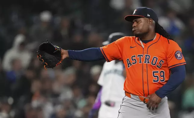 Houston Astros starting pitcher Framber Valdez points after the end of the third inning of a baseball game against the Seattle Mariners, Tuesday, April 8, 2025, in Seattle. (AP Photo/Lindsey Wasson)