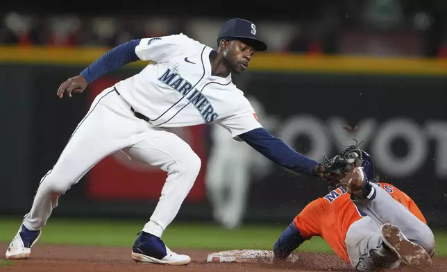 Seattle Mariners second baseman Ryan Bliss catches Houston Astros' Jake Meyers attempting to steal second base during the fifth inning of a baseball game Tuesday, April 8, 2025, in Seattle. (AP Photo/Lindsey Wasson)