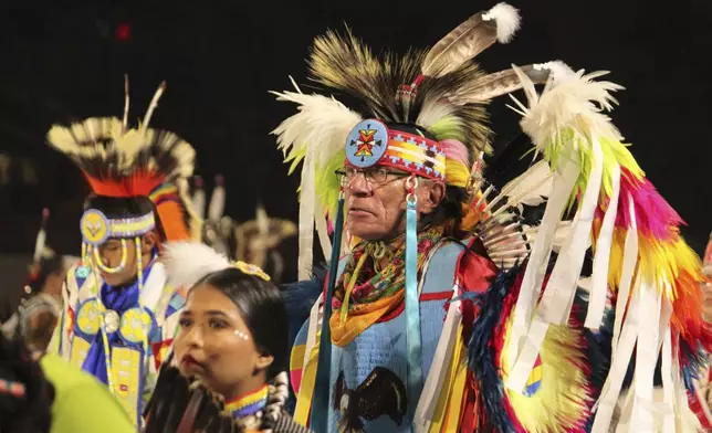 Native American and Indigenous dancers pack an arena during a grand entry procession at the annual Gathering of Nations powwow in Albuquerque, New Mexico, Friday, May 25, 2025. (AP Photo/Susan Montoya Bryan)