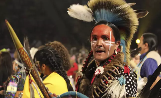 Native American and Indigenous dancers take part in a grand entry procession at the annual Gathering of Nations powwow in Albuquerque, New Mexico, on Friday, May 25, 2025 (AP Photo/Susan Montoya Bryan)