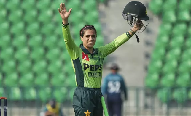 Pakistan's Sidra Amin celebrates after scoring fifty during the ICC Women's World Cup Qualifier match between Pakistan and Thailand at the Gaddafi Stadium, in Lahore, Pakistan, Thursday, April 17, 2025. (AP Photo/K.M. Chaudary)