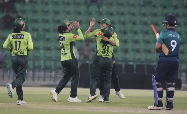 Pakistani players celebrate their win at the ICC Women's World Cup Qualifier match against Thailand in the Gaddafi Stadium, in Lahore, Pakistan, Thursday, April 17, 2025. (AP Photo/K.M. Chaudary)