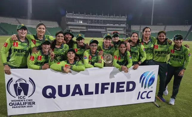 Pakistani players pose for photograph after winning the match against Thailand and qualifying for ICC Women's World Cup, at the Gaddafi Stadium, in Lahore, Pakistan, Thursday, April 17, 2025. (AP Photo/K.M. Chaudary)