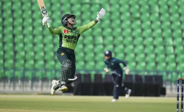Pakistan's Sidra Amin celebrates after scoring fifty during the ICC Women's World Cup Qualifier match between Pakistan and Thailand at the Gaddafi Stadium, in Lahore, Pakistan, Thursday, April 17, 2025. (AP Photo/K.M. Chaudary)