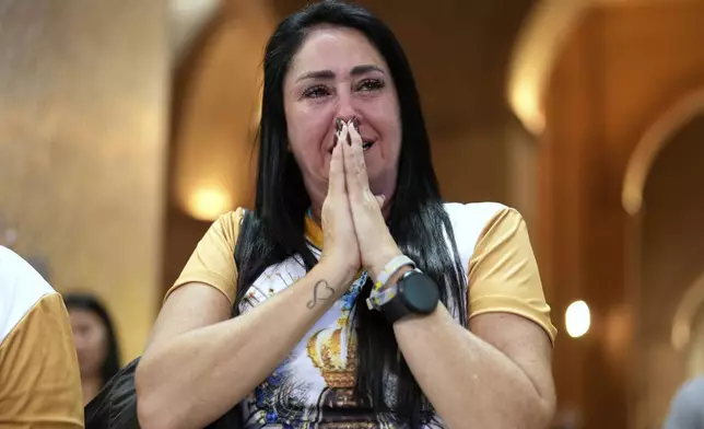 A woman cries during Mass at Sanctuary of Our Lady of Aparecida, following the Vatican’s announcement of Pope Francis’ death, in Aparecida, Brazil, Monday, April 21, 2025. (AP Photo/Andre Penner)