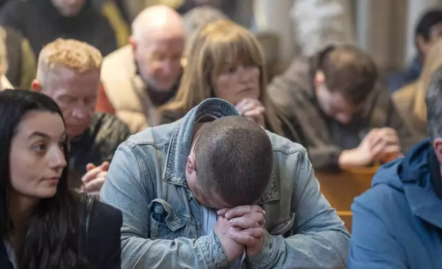 Members of the congregation pray during a special Easter Monday Mass at St Andrew's RC Metropolitan Cathedral in Glasgow, Scotland, Monday April 21, 2025, following the announcement by the Vatican of the death of Pope Francis. (Jane Barlow/PA Wire/PA via AP)