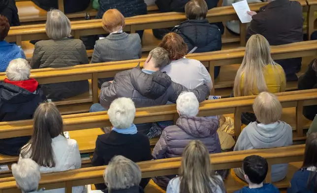 Members of the congregation pray during a special Easter Monday Mass at St Andrew's RC Metropolitan Cathedral in Glasgow, Scotland, Monday April 21, 2025, following the announcement by the Vatican of the death of Pope Francis. (Jane Barlow/PA via AP)