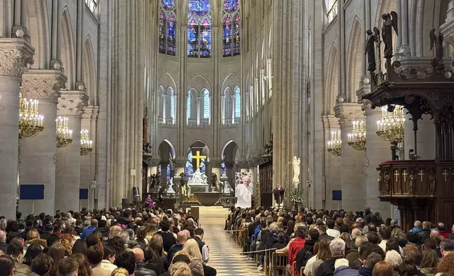 Worshippers attend a mass inside Notre Dame cathedral Monday, April 21, 2025 in Paris. (AP Photo/Nicolas Garriga)