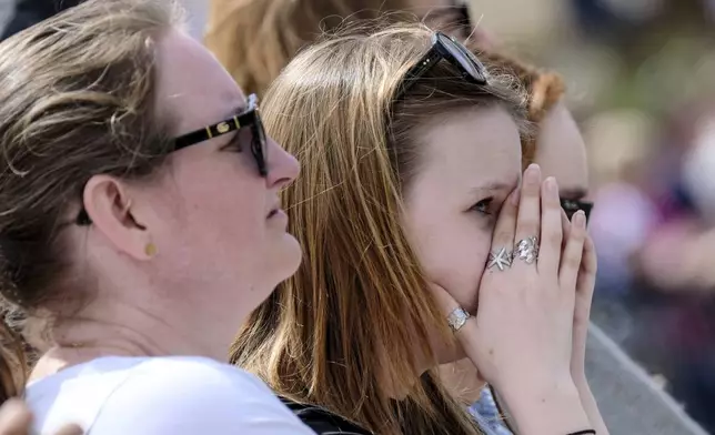 Faithful react to the news of Pope Francis' death in St. Peter's Square at the Vatican, Monday, April 21, 2025. (Mauro Scrobogna/LaPresse via AP)