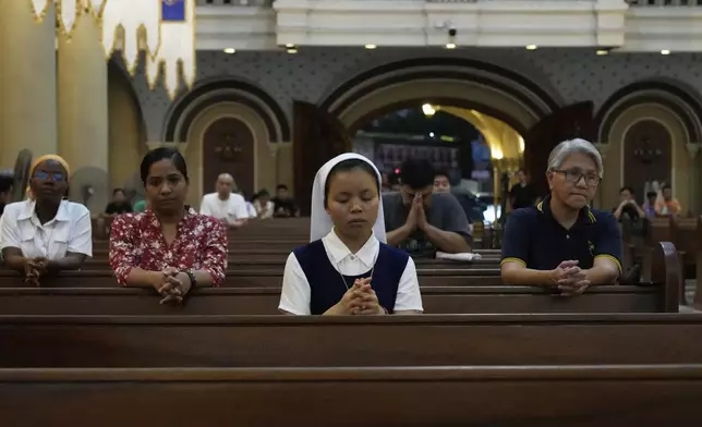 Devotees pray during a mass for the late Pope Francis at the Cubao Cathedral in Quezon city, Philippines Monday, April 21, 2025. (AP Photo/Aaron Favila)