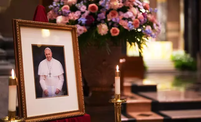 A picture of Pope Francis is displayed inside the Cathedral Basilica of Saints Peter and Paul, Monday, April 21, 2025, in Philadelphia. (AP Photo/Matt Slocum)