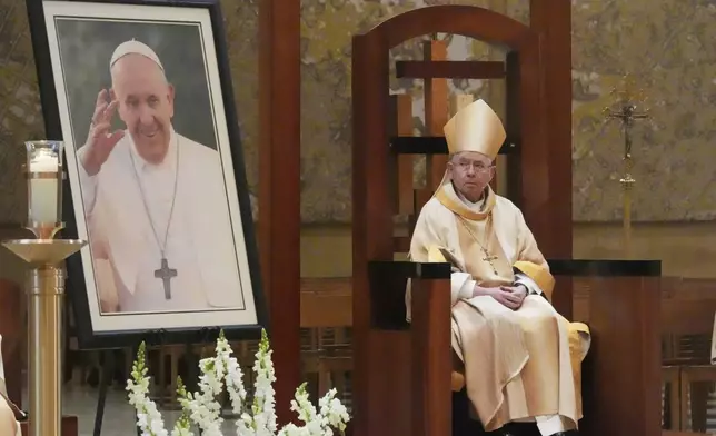 Jose H. Gomez, Archbishop of Los Angeles, sits behind an image of Pope Francis during a service in the Pope's honor at the Cathedral of Our Lady of Angels, Monday, April 21, 2025, in Los Angeles. (AP Photo/Damian Dovarganes)