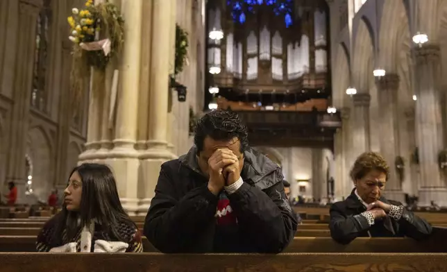 Parishioners pray at St. Patrick's Cathedral, Monday, April 21, 2025, in New York. (AP Photo/Yuki Iwamura)