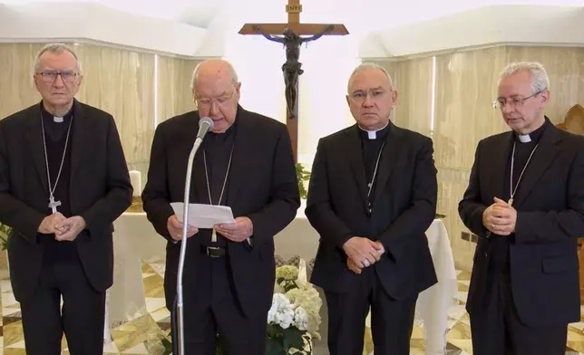 In this image released by Vatican media on Monday, April 21, 2025, Cardinal Camerlengo Kevin Joseph Farrell, second from left, flanked by, from left, Vatican Secretary of State Cardinal Pietro Parolin, Vatican Substitute for the Secretariat of State, Cardinal Edgar PeÒa Parra, and Vatican Master of Ceremonies, Archbisop Diego Giovanni Ravelli, announces the death of Pope Francis at the Vatican. (Vatican Media via AP)