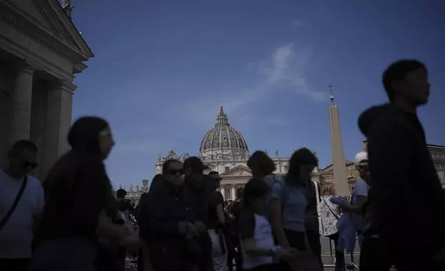 People gather in St. Peter's Square at the Vatican after the Vatican announced the death of Pope Francis, Monday, April 21, 2025. (AP Photo/Alessandra Tarantino)