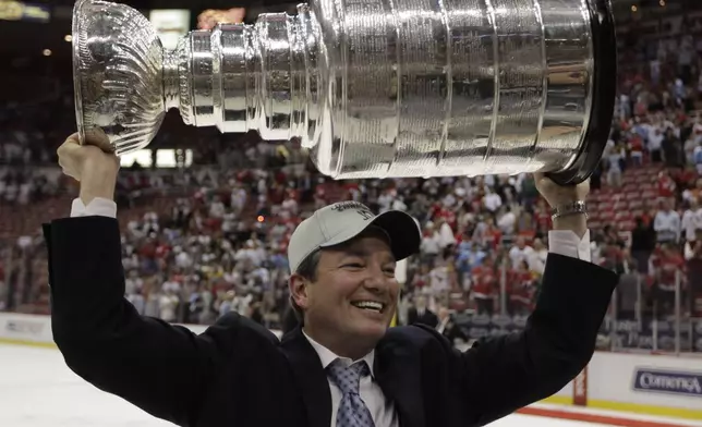 FILE - Pittsburgh Penguins general manager Ray Shero holding up the Stanley Cup after the Penguins beat the Detroit Red Wings 2-1 to win Game 7 of the NHL hockey Stanley Cup finals, in Detroit, June 12, 2009. (AP Photo/Paul Sancya, File)
