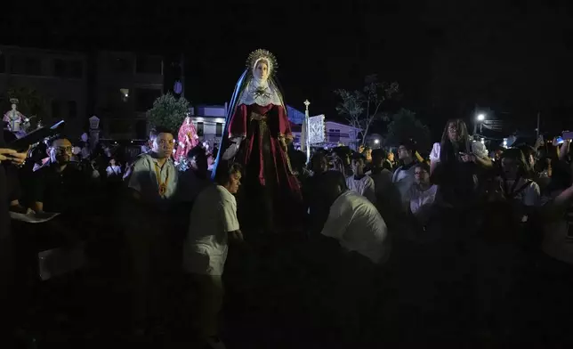 Statues depicting the life and sufferings of Jesus Christ and other saints are pushed by devotees around town to mark Holy Wednesday in Paete, Laguna province, Philippines, April 16, 2025. (AP Photo/Aaron Favila)
