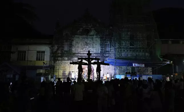 Devotees hold an evening procession with statues depicting the life and sufferings of Jesus Christ as part of their lenten practice to mark Holy Wednesday in Paete, Laguna province, Philippines, April 16, 2025. (AP Photo/Aaron Favila)