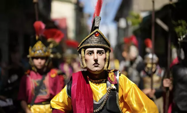 Performers dressed as Roman soldiers walk around town as they reenact the passion and sufferings of Jesus Christ to mark Maundy Thursday April 17, 2025 in Paete town, Laguna province, Philippines. (AP Photo/Aaron Favila)
