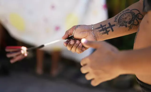 A penitents flagellates himself on Good Friday in Kalayaan town, Laguna province, Philippines, April 18, 2025. (AP Photo/Aaron Favila)