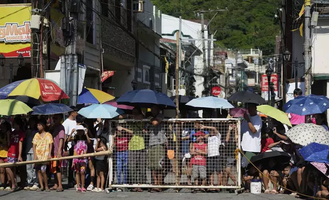 People watch a reenactment of the crucifixion of Jesus Christ on Maundy Thursday in Paete town, Laguna province, Philippines, April 17, 2025. (AP Photo/Aaron Favila)