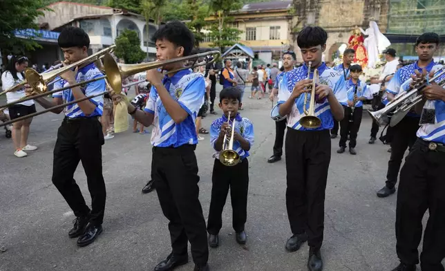 A band plays at the start of an evening procession of statues depicting the life and sufferings of Jesus Christ as part of their lenten practice to mark Holy Wednesday in Paete, Laguna province, Philippines, April 16, 2025. (AP Photo/Aaron Favila)