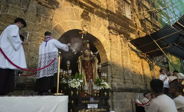 A Catholic priest performs a ritual as part of lenten practice to mark Holy Wednesday in Paete, Laguna province, Philippines, April 16, 2025. (AP Photo/Aaron Favila)