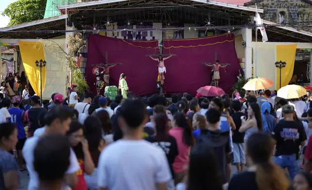 People watch a reenactment of the crucifixion of Jesus Christ to mark Maundy Thursday April 17, 2025 in Paete town, Laguna province, Philippines. (AP Photo/Aaron Favila)