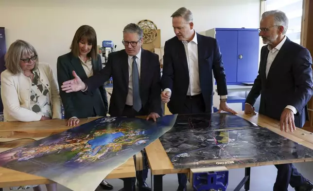 British Prime Minister Keir Starmer, centre, Chancellor of the Exchequer Rachel Reeves, second from left, President of Comcast Corporation Michael Cavanagh, Chief Executive of Bedford Borough Council Laura Church, left, and Chairman and CEO of Universal Destinations &amp; Experiences Mark Woodbury, right, meet on the day of an announcement that U.S. media giant Comcast Corp will build its first Universal theme park and resort in Europe, opening in 2031, during a visit to Bedford, north of London, Wednesday April 9, 2025. (John Sibley/Pool Photo via AP)
