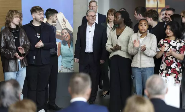 People applaud as British Prime Minister Keir Starmer attends an announcement that U.S. media giant Comcast Corp will build its first Universal theme park and resort in Europe, opening in 2031, during a visit to Bedford, north of London, Wednesday April 9, 2025. (John Sibley/Pool Photo via AP)