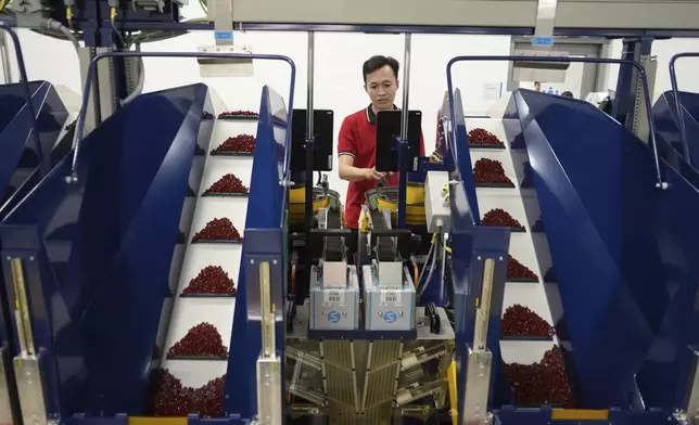 A worker operates packing machines at Lego factory in Binh Duong, Vietnam Wednesday, April 2, 2025. (AP Photo/Hau Dinh)
