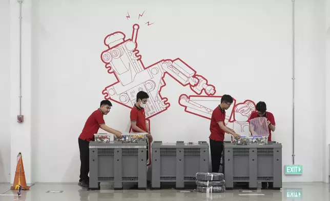 Workers sort out Lego bricks at Lego factory in Binh Duong, Vietnam Wednesday, April 2, 2025. (AP Photo/Hau Dinh)