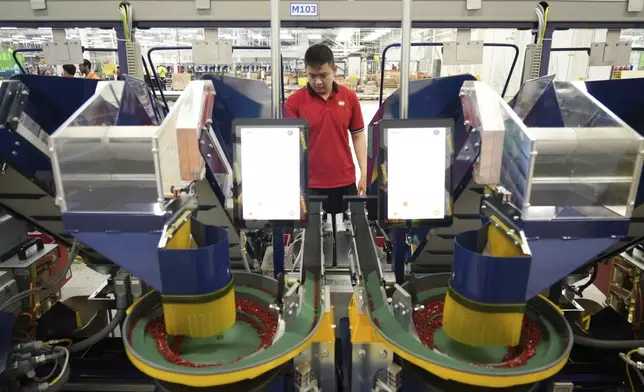A worker operates packing machines at Lego factory in Binh Duong, Vietnam Wednesday, April 2, 2025. (AP Photo/Hau Dinh)