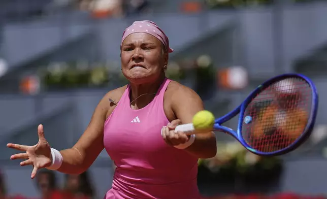 Russia's Diana Shnaider returns the ball against Iga Swiatek of Poland during the Madrid Open tennis tournament in Madrid, Spain, Tuesday, April 29, 2025. (AP Photo/Manu Fernandez)