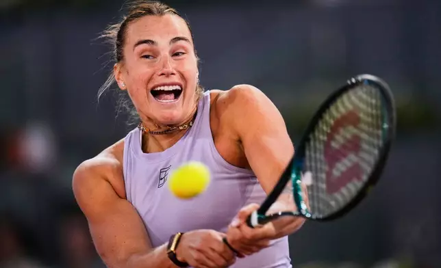 Aryna Sabalenka of Belarus, hits a return to United States' Peyton Stearns during the Madrid Open tennis tournament in Madrid, Spain, Tuesday, April 29, 2025. (AP Photo/Manu Fernandez)