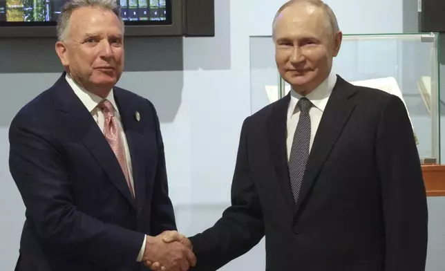 Russian President Vladimir Putin, right, and U.S. President Donald Trump's special envoy Steve Witkoff shake hands prior to their talks in St. Petersburg, Russia, Friday, April 11, 2025. (Gavriil Grigorov, Sputnik, Kremlin Pool Photo via AP)