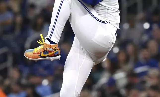 Toronto Blue Jays starting pitcher Jose Berrios winds up to throw to a Seattle Mariners batter in first-inning baseball game action in Toronto, Saturday, April 19, 2025. (Jon Blacker/The Canadian Press via AP)