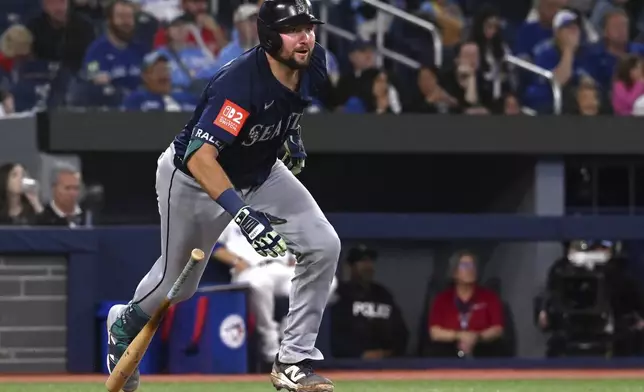 Seattle Mariners catcher Cal Raleigh (29) hits a two run double against the Toronto Blue Jays in fifth inning American League baseball action in Toronto on Saturday, April 19, 2025. (Jon Blacker/The Canadian Press via AP)