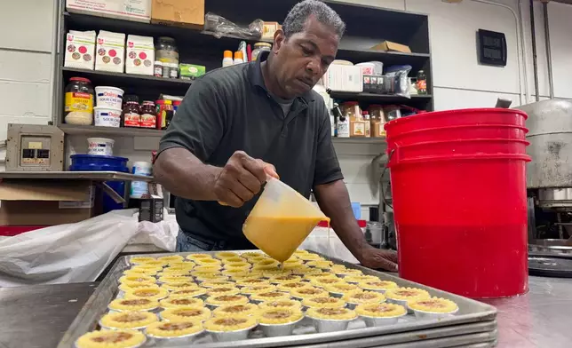 Jerry Clifton, 56, a Loretta's Pralines baker, prepares confections on Tuesday, April 22, 2025, for the New Orleans Jazz and Heritage Festival. (AP Photo/Jack Brook)