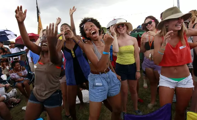 FILE - Audience members dance during the "Bounce Shakedown" at the New Orleans Jazz and Heritage Festival in New Orleans, Sunday, May 6, 2012. (AP Photo/Gerald Herbert, File)