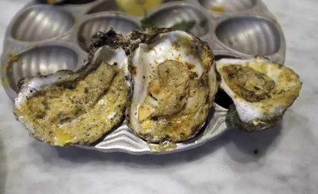 FILE - Baked oysters are displayed at the Bourbon House Restaurant in New Orleans, Tuesday, June 24, 2014. (AP Photo/Gerald Herbert, File)