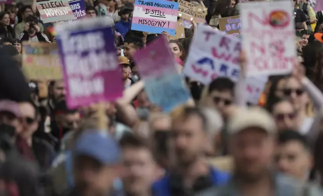 Campaigners take part in a rally organised by trans rights groups, trade unions, and community organisations following the Supreme Court ruling on the definition of a woman in equalities law, at Parliament Square, central London, Saturday April 19, 2025. (AP Photo/Alastair Grant)