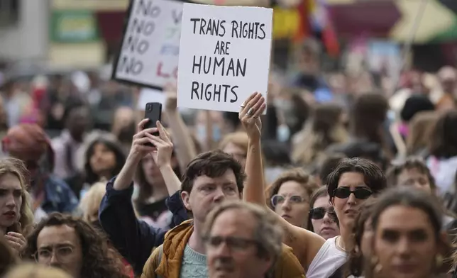 Campaigners take part in a rally organised by trans rights groups, trade unions, and community organisations following the Supreme Court ruling on the definition of a woman in equalities law, at Parliament Square, central London, Saturday April 19, 2025. (AP Photo/Alastair Grant)